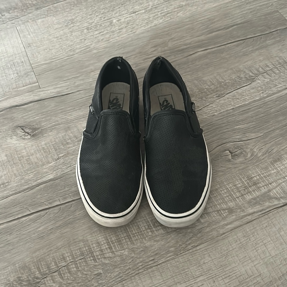 Black vans slip ons.